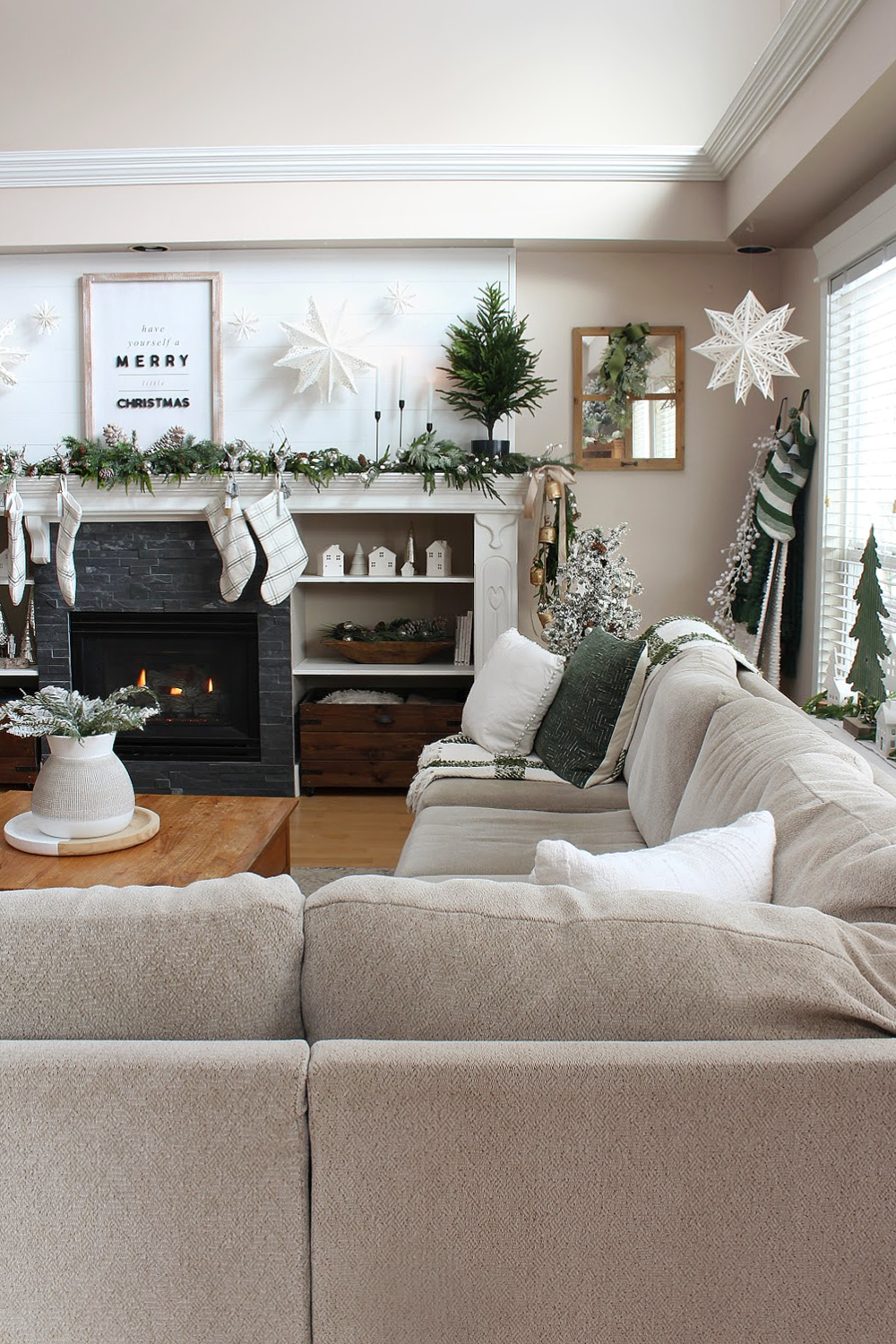 Living room decorated for Christmas with green and white.