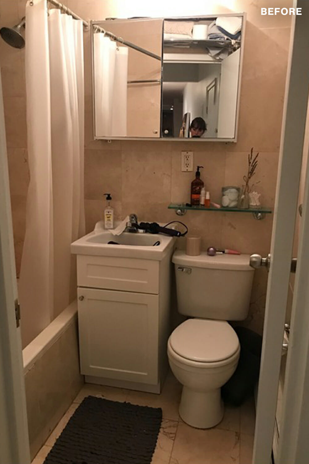 bathroom-with-pink-walls-before-renovation compact bathroom with single vanity and medicine cabinet and pink tiles walls and floor and bathtub before renovation
