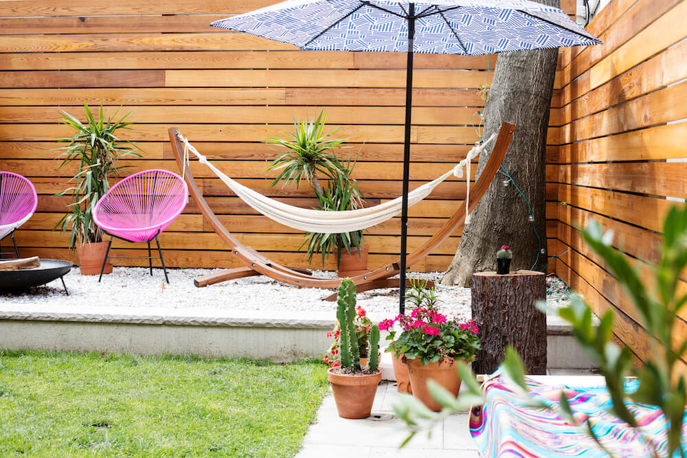 NYC backyard with cedar fence, gravel siding and hammock seating